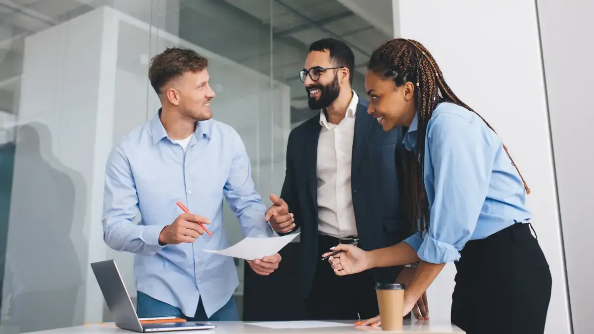 Two business partners exchanging a document
